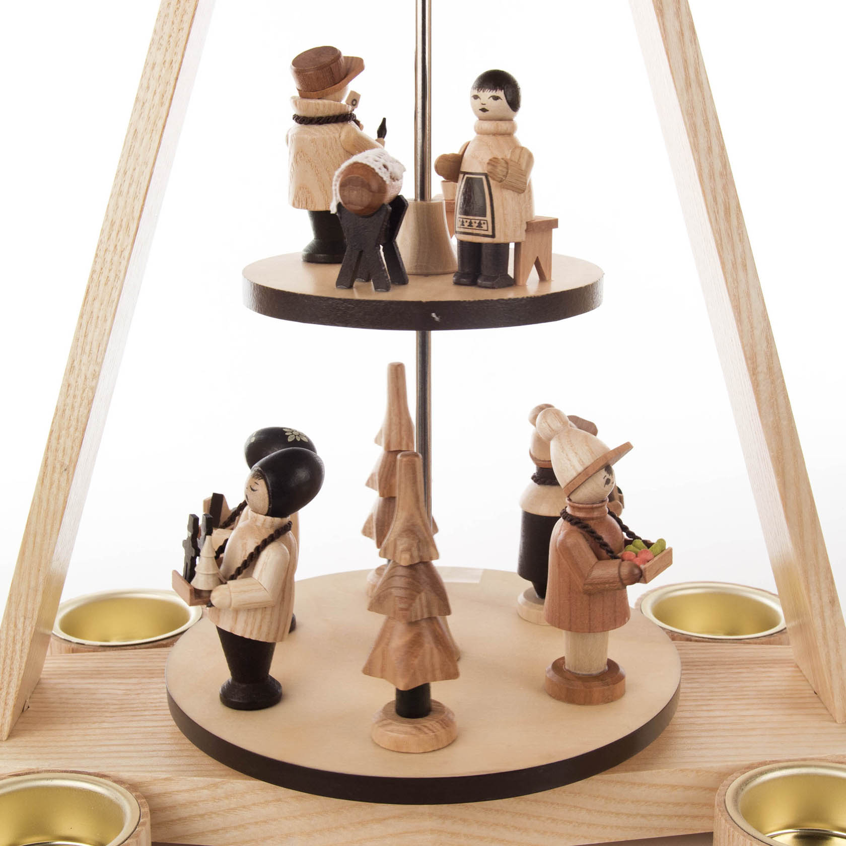 A two-tiered wooden pyramid featuring small handcrafted wooden figures, including a painter, musician, and people holding items, designed for tealights.
