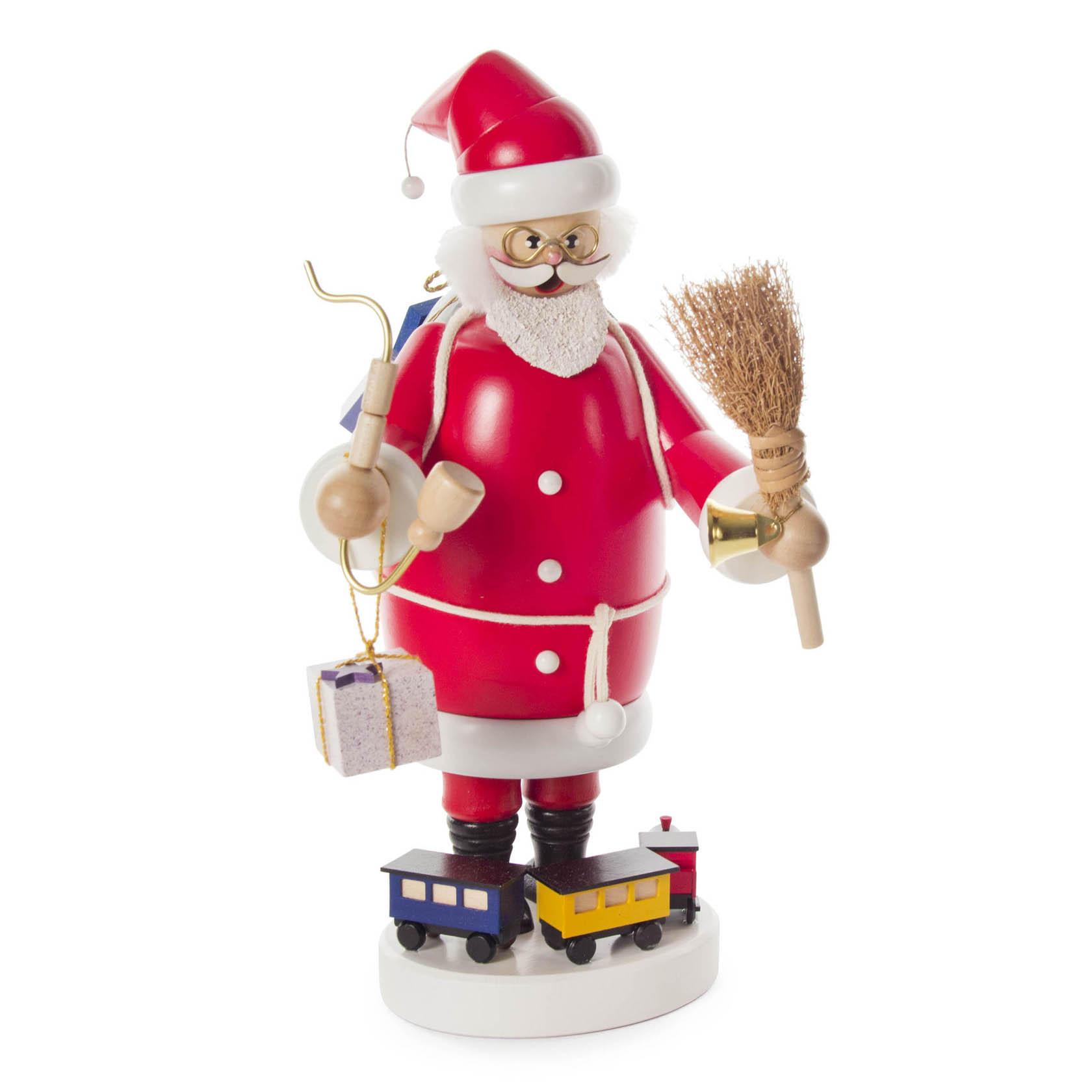A traditional red incense smoker figurine depicting Santa Claus with a white beard, holding a small broom and a wrapped gift, featuring two toy trains at his feet. im Dregeno Online Shop günstig kaufen
