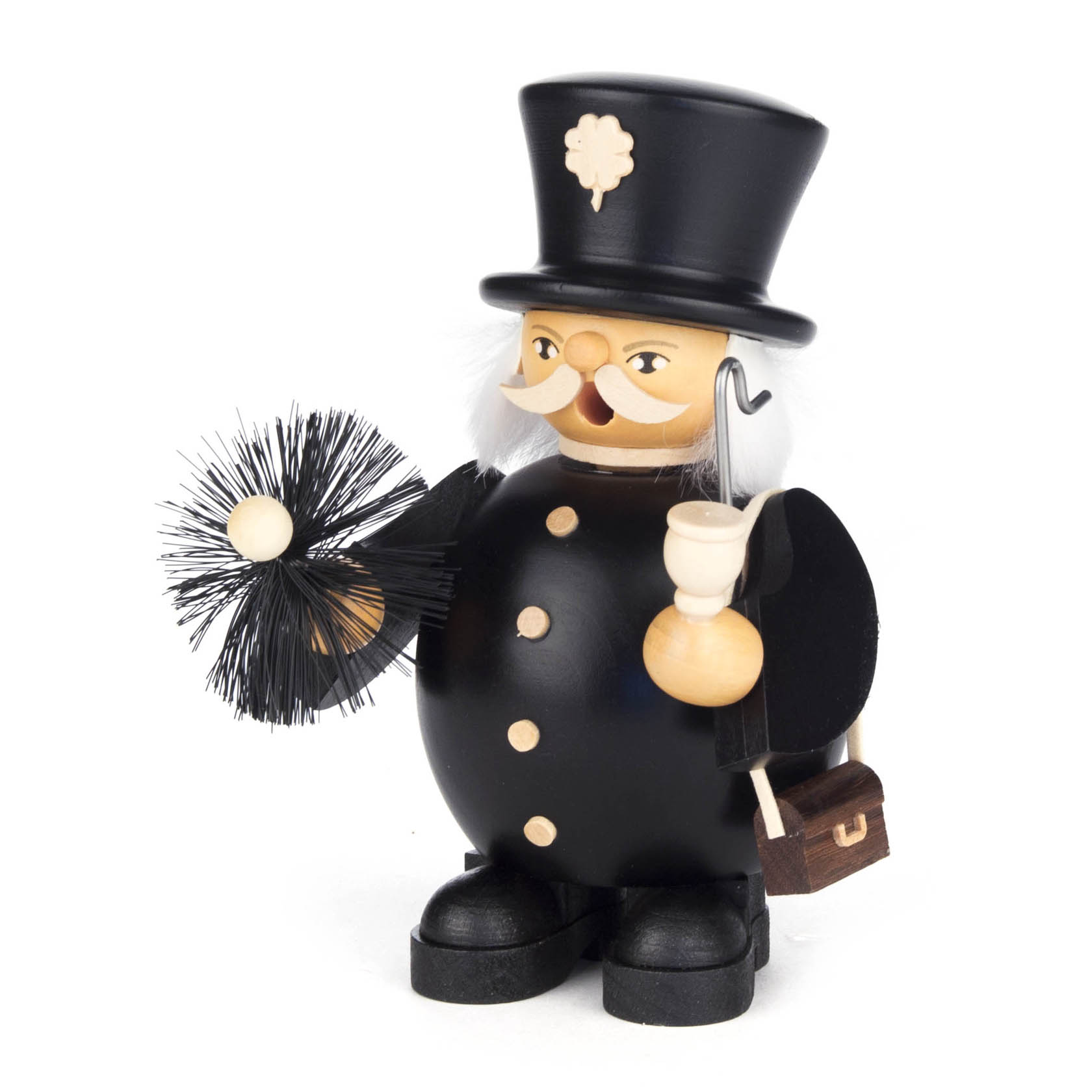 A decorative wooden chimney sweep figure with a smiling face, holding a pipe in one hand and a chimney brush in the other. It wears a black top hat and jacket.