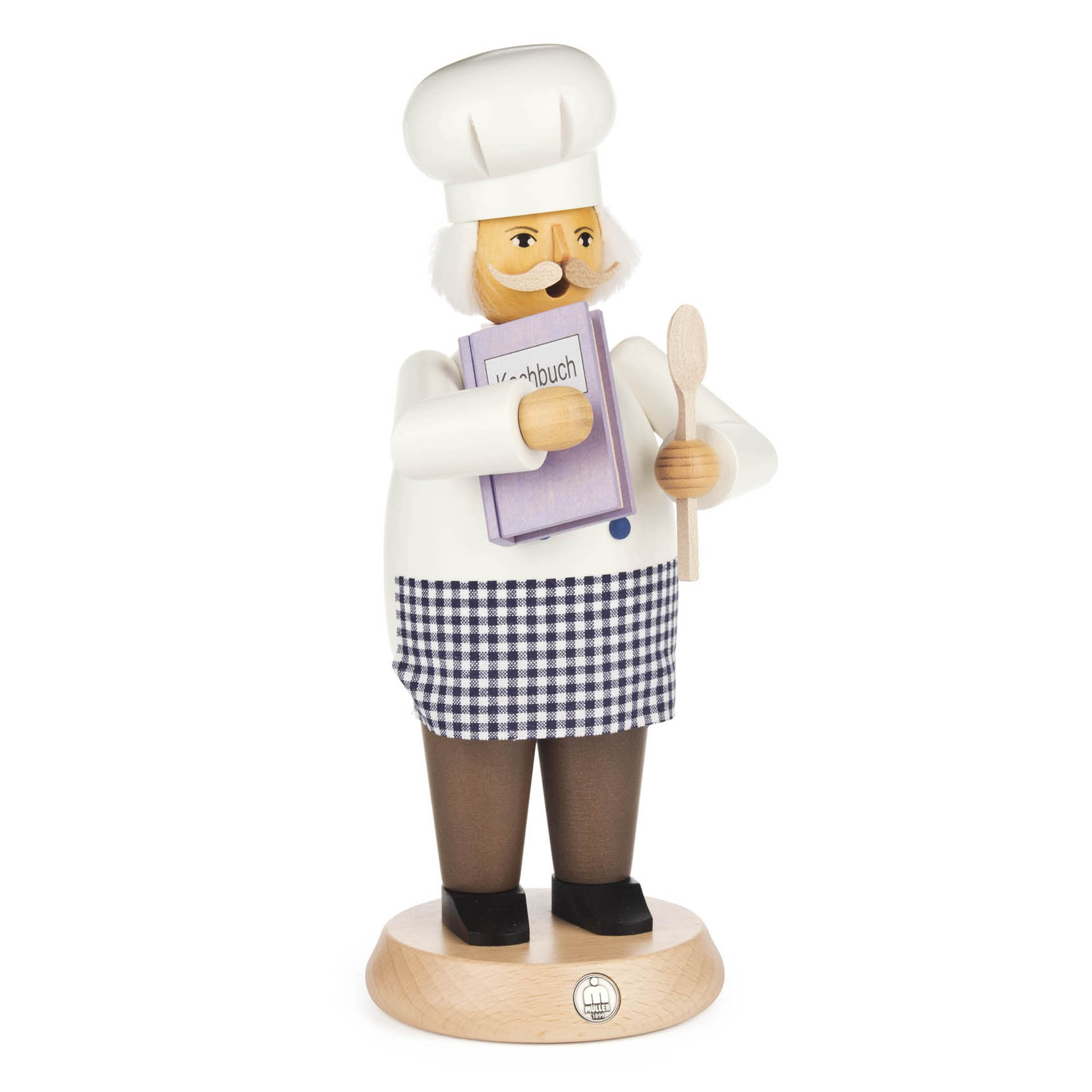 Holzfigur eines Kochs mit weißer Kochmütze und Schürze, der ein Kochbuch und einen Holzlöffel hält.